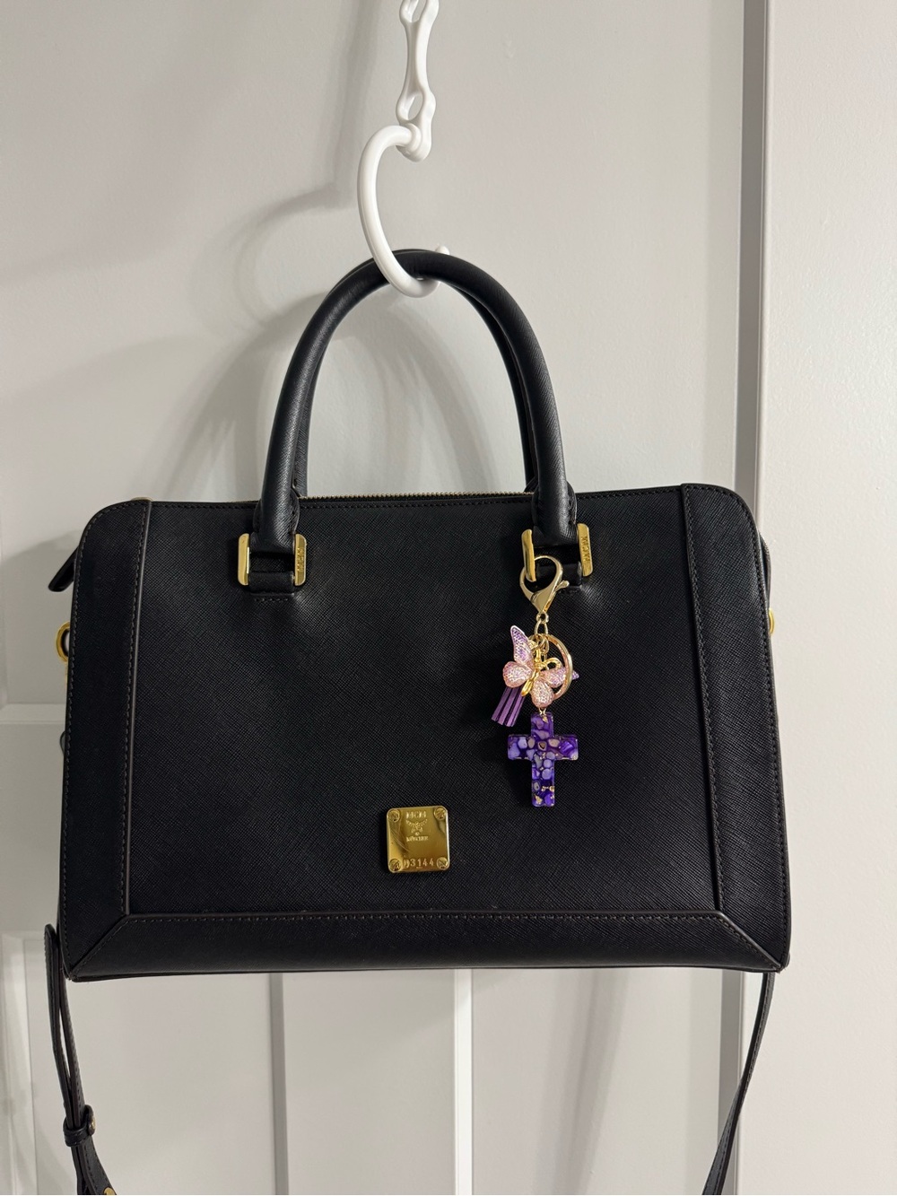 MCM Black Satchel with Gold-Tone Hardware and Purple Charm